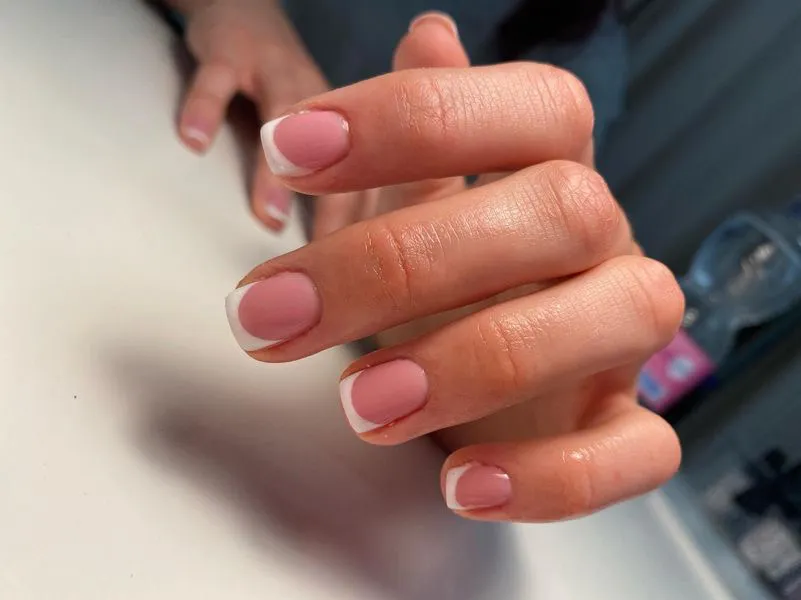 Short natural nails with a classic French tip