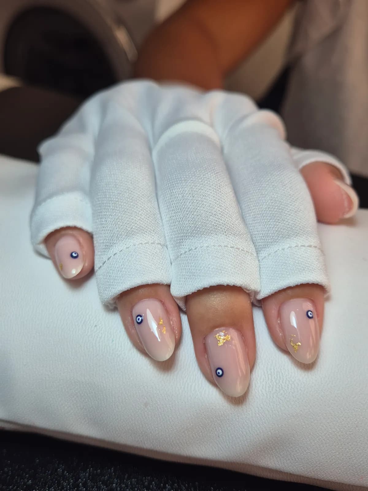 Nude almond nails with small crystals and gold foil
